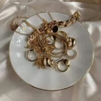 Assorted chains, rings and earrings on a plate